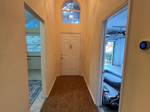 front door, kitchen off to left and garage on the right.