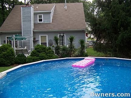 Back yard pool with deck. Also has a shed and green space.