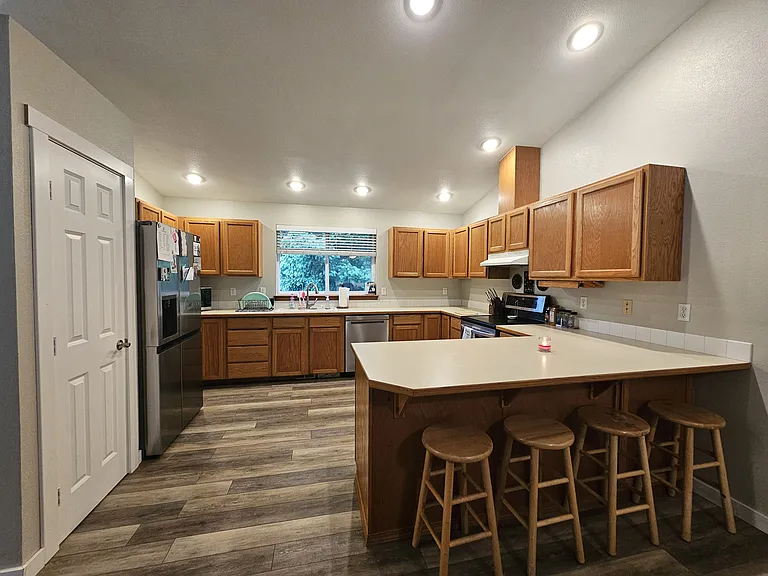 Large kitchen with plenty of cabinet storage and counter space. New stainless steal appliances.