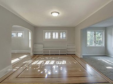 Hardwood floors throughout the house, with a carpeted sunroom in front and one carpeted bedroom.