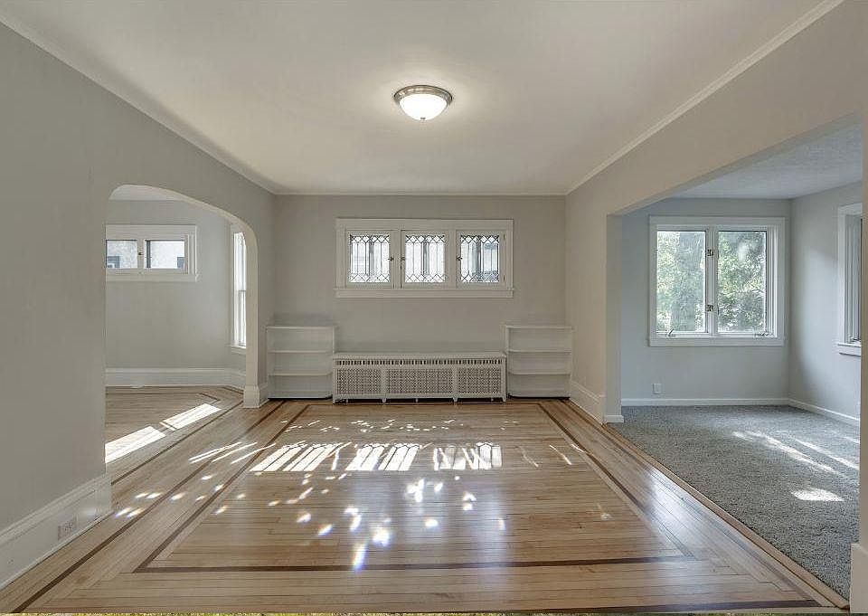 Hardwood floors throughout the house, with a carpeted sunroom in front and one carpeted bedroom.