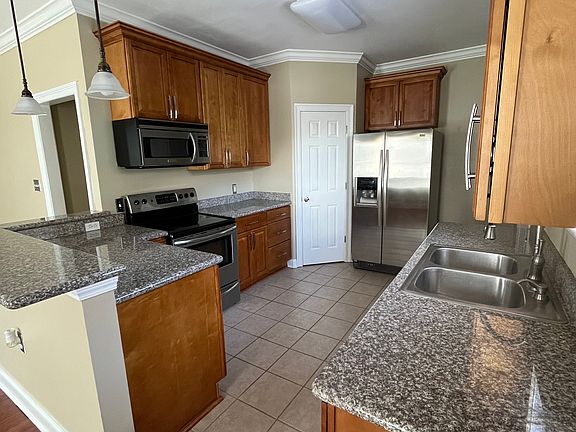 Kitchen includes refrigerator, microwave, dishwasher, and oven.