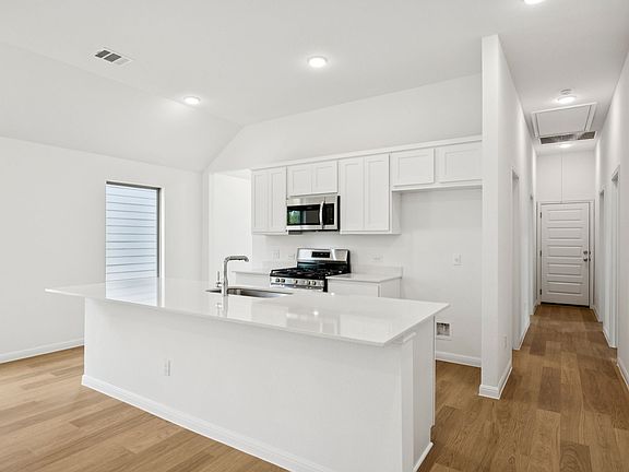 Kitchen in the Spruce home plan by Trophy Signature Homes - REPRESENTATIVE PHOTO