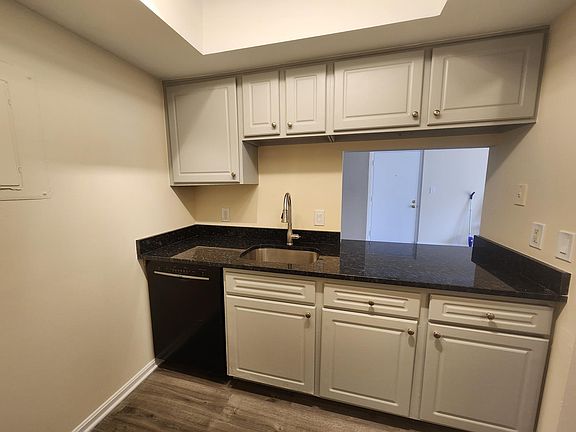 Brand-new granite countertop and painted cabinets
