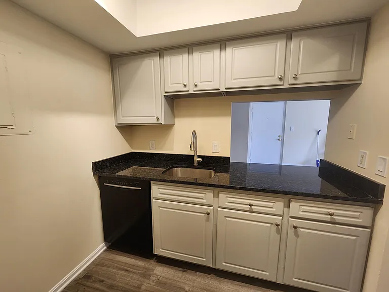 Brand-new granite countertop and painted cabinets