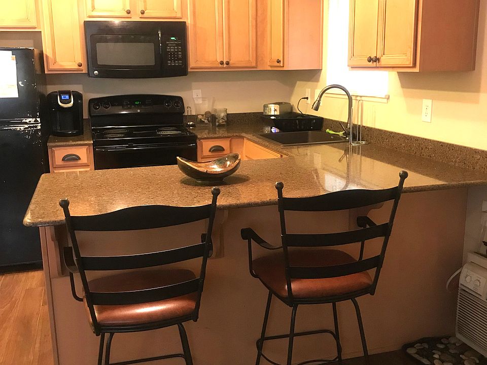 Completely updated kitchen with Silestone counters. Chairs stay if desired. The kitchen is immediately to the right as you enter the condo, directly opposite the living room, creating a nice open space.