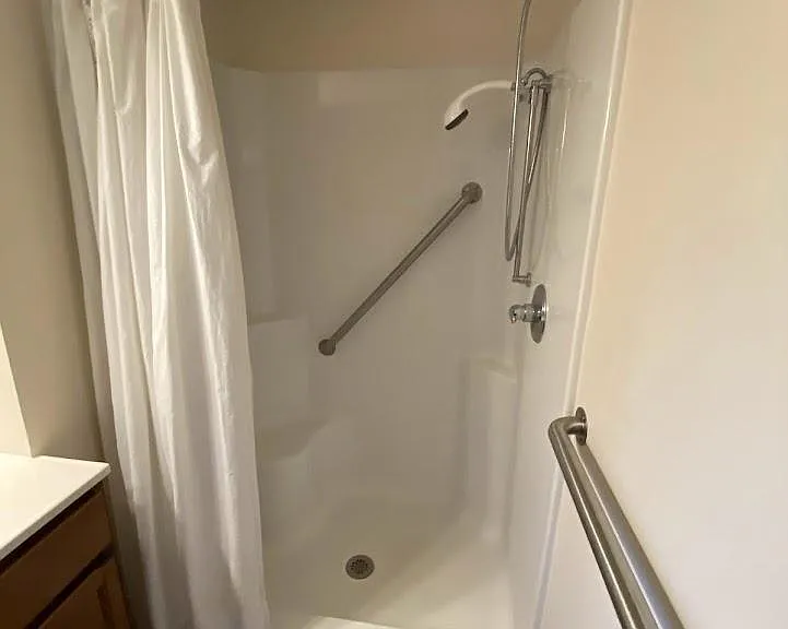 Bathroom on the first floor with shower and includes a stackable washer dryer hook up