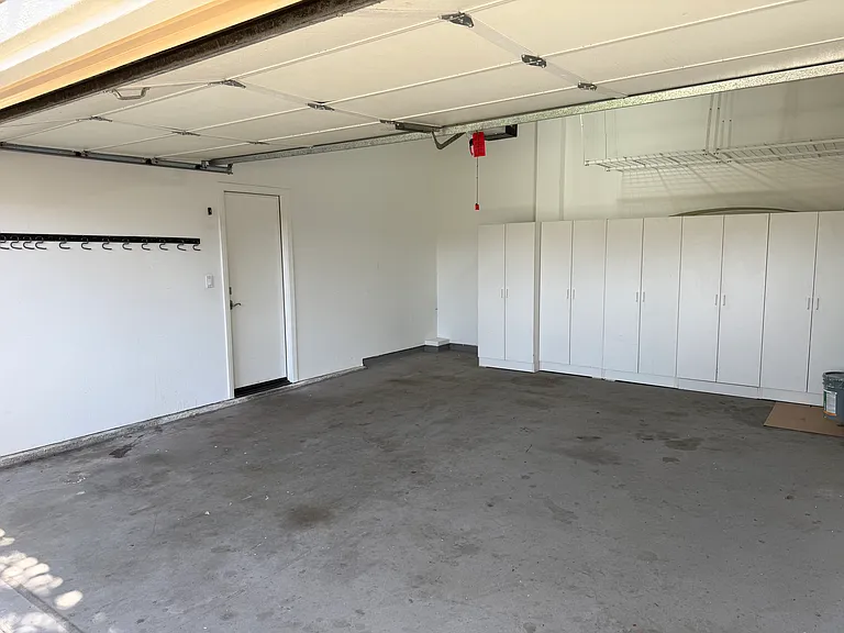 garage with built-in cabinets, overhead storage racks