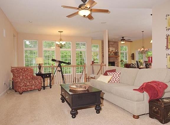 Open greatroom features built-in entertainment center, frieze carpet and bright wall of windows to enjoy your serene view of your wooded oasis! Opens to kitchen, hearth room and breakfast room.