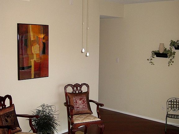 Living Room features hardwood flooring and vaulted ceiling.