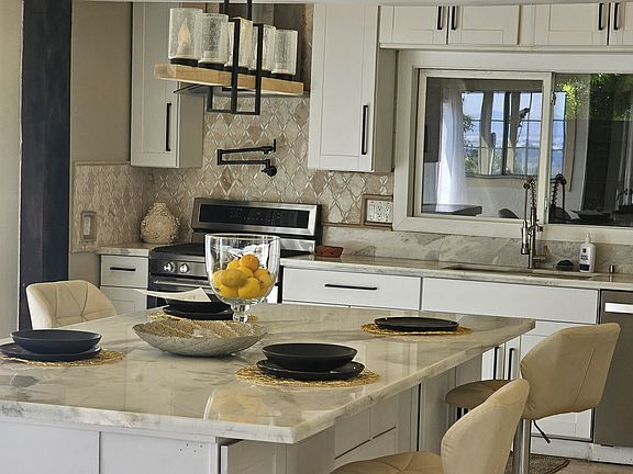 Open kitchen with stove and refrigerator