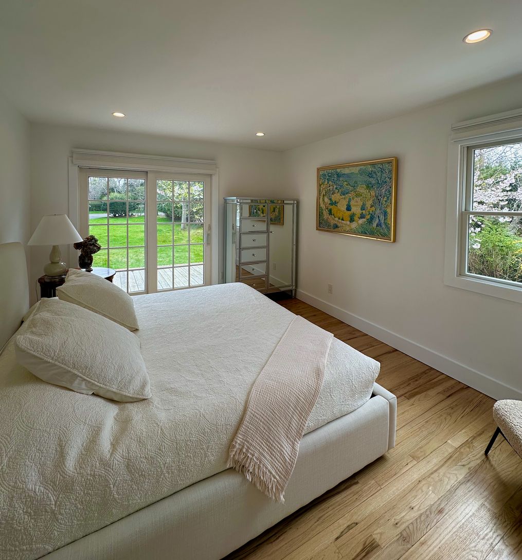  main level bedroom with king bed, doors open to front yard patio