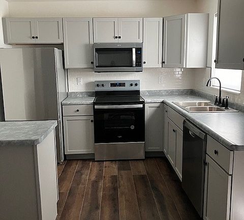 Brand new kitchen with subway tile backsplash and stainless steel appliances!