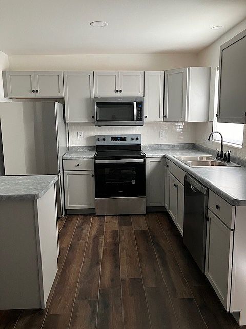 Kitchen with subway tile backsplash and stainless steel appliances!