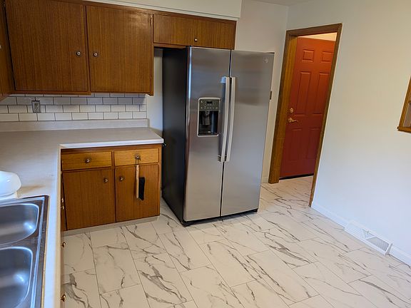 Kitchen showing entry to garage and basement stairs