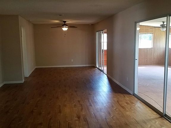 Looking back from fireplace with playroom on the right side. Drapery rods and drapes currently installed in bronze colors, across right walls/doors.