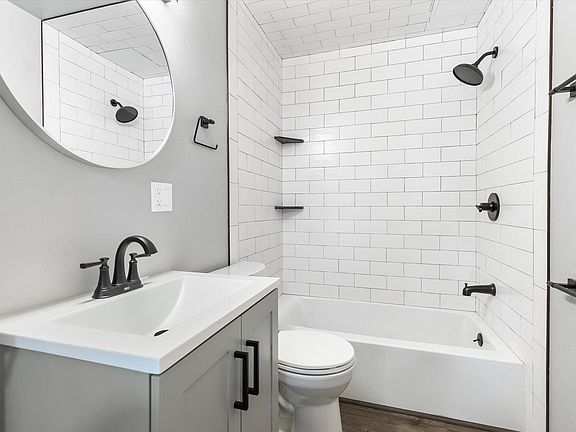 Newly renovated bathroom with subway tile shower and black fixtures.