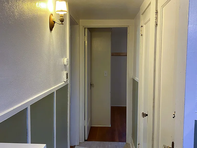 hallway kitchen to living room & bedroom. Door to basement.