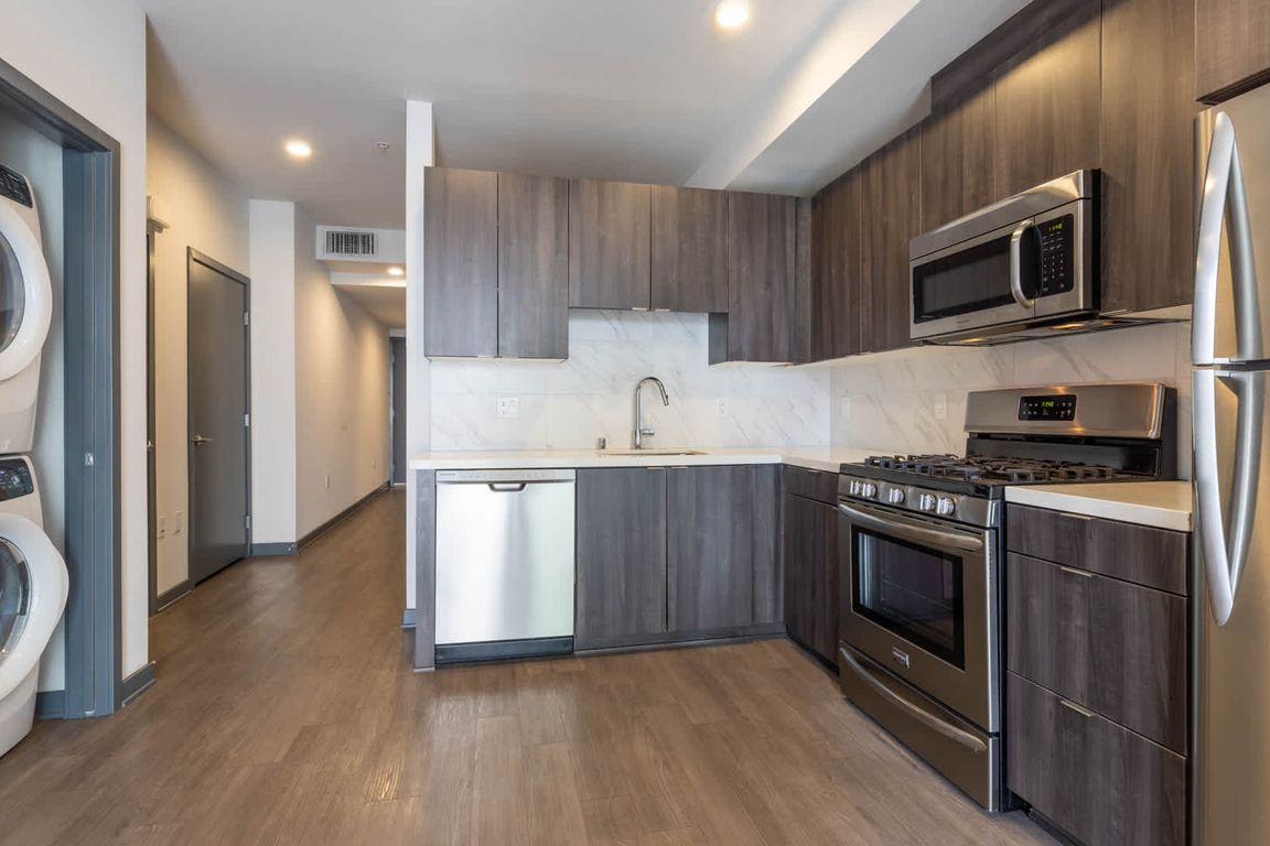 Kitchen with Stainless Steel Appliances and In-home Washer and Dryer