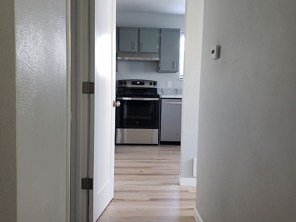 HALL TO HALF BATH, UTILITY ROOM AND KITCHEN.