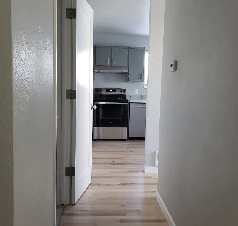 HALL TO HALF BATH, UTILITY ROOM AND KITCHEN.