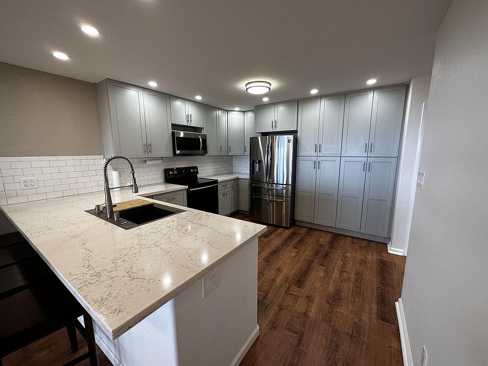 Beautiful kitchen with two full pantries with seating for four at bar.