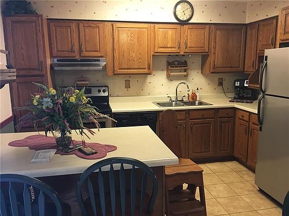 The beautiful kitchen was updated. Notice the peninsula and many cabinets for storage. The electric range and dishwasher will re