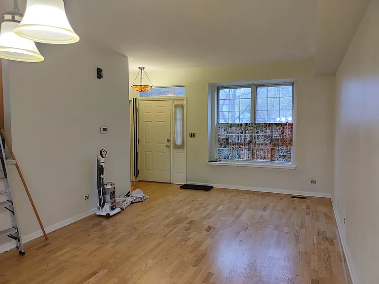 View of front door from the dining room. Next to the front door to the left is 1/2 bath on the first floor.