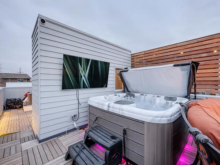 Ta-da! The legendary rooftop features a hot tub with ALL THE JETS, to reward your legs after climbing 3 flights stairs to get here. There are custom lights, & you can even play music from the hot tub, though our Sonos speaker and Smart TV sound best!