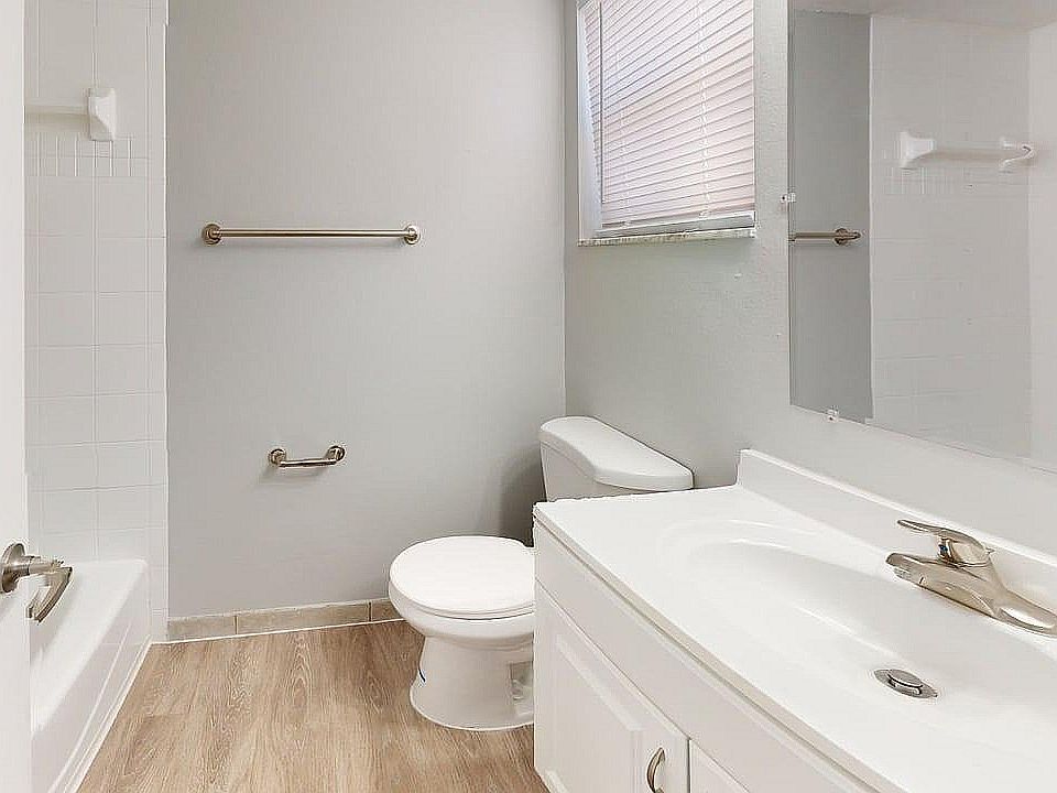 Bright and modern bathroom showcasing sleek fixtures, elegant sink, and inviting bathtub with a serene ambiance.