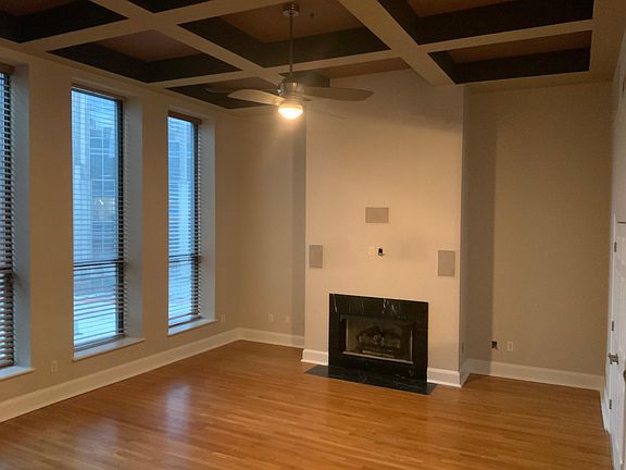 Large living area; coffered 22ft ceilings; gas fireplace; built-in TV / surround sound cable hookups