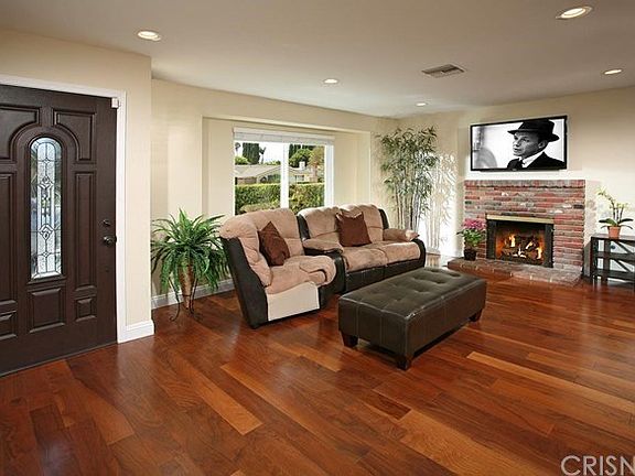 The spacious living room is bathed in natural ligh
