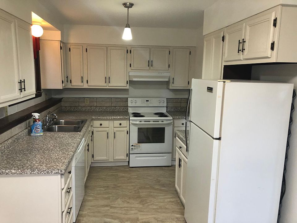 Kitchen with new countertop, new flooring, freshly sanded and painted cabinets, stove, fridge and dishwasher provided