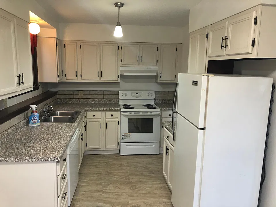 Kitchen with new countertop, new flooring, freshly sanded and painted cabinets, stove, fridge and dishwasher provided