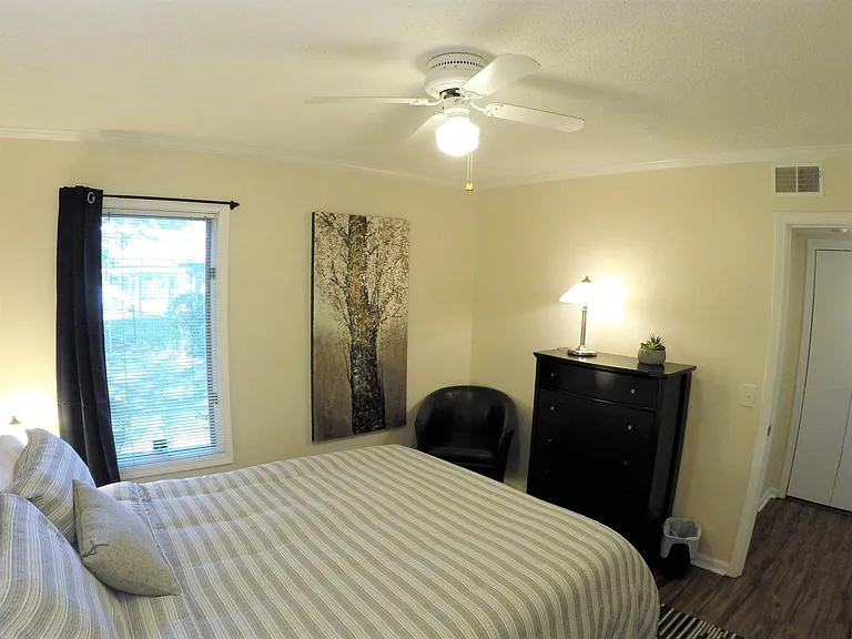 Room darkening curtain. 2nd bathroom located right around the corner.