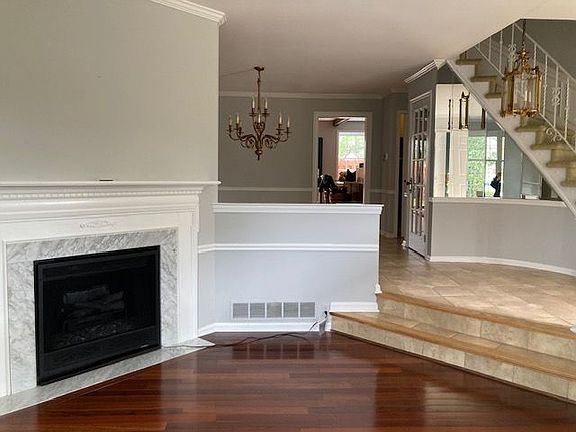 Sunk In living room with electric fireplace. Beautiful crown molding throughout. Tile in entrance way/dining room/hall bath