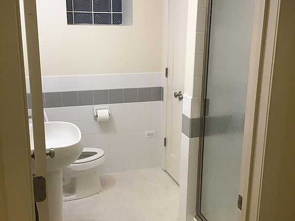 bathroom with shower and linen closet