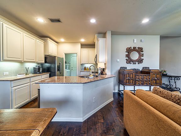 Kitchen view open to laundry area, breakfast nook and living area