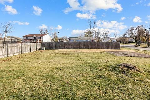 spacious, partially-fenced back yard