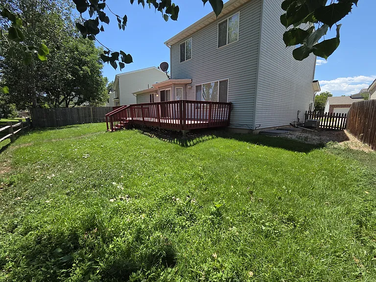 Back deck and yard space, opens to HOA managed open space