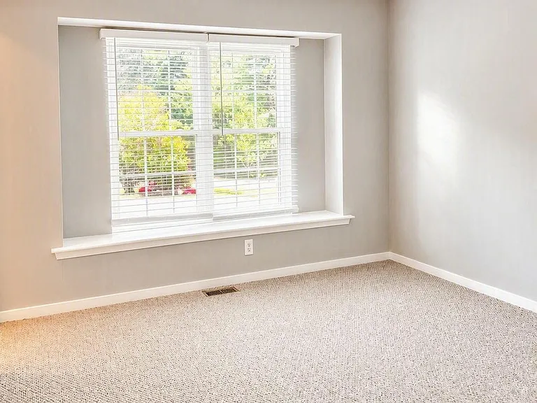 Master bedroom with window bench and walk-in closet
