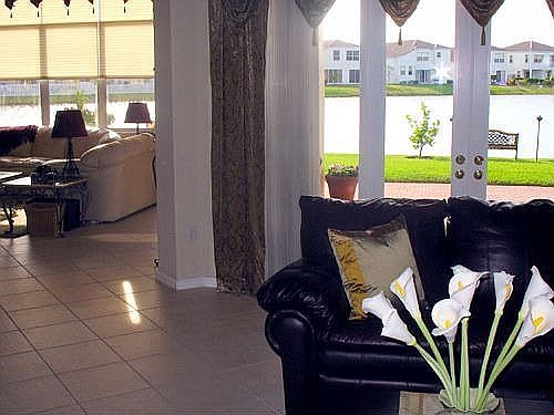 From living room into family room and looking out the French doors to lake.