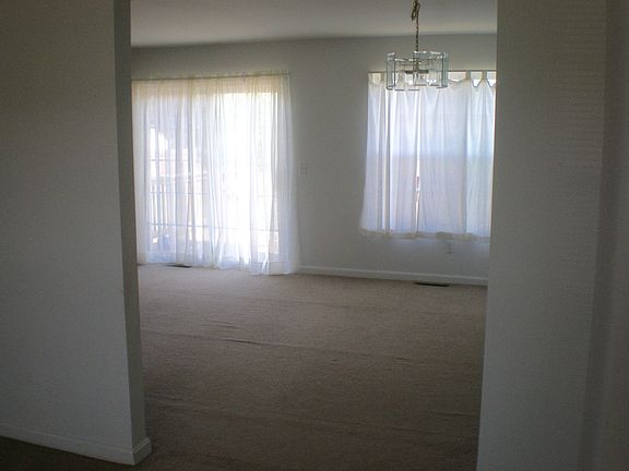 Dining room now has laminate flooring with ceiling fan.