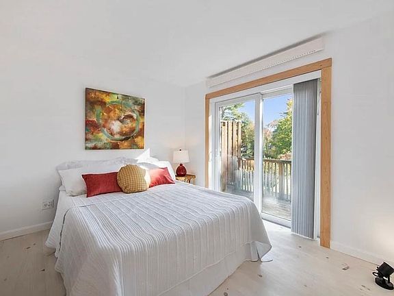 Bedroom with wood floor and balcony access