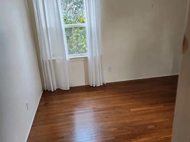 Bedroom with new double pane windows for noise reduction and energy conservation, curtains