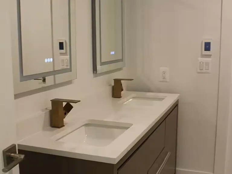 Double vanity. Lighted medicine cabinets with makeup mirror, plugs, and charging ports.