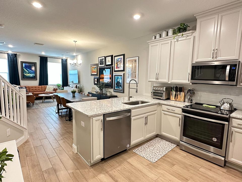 Open kitchen, dining, living room. Some artwork has been updated.