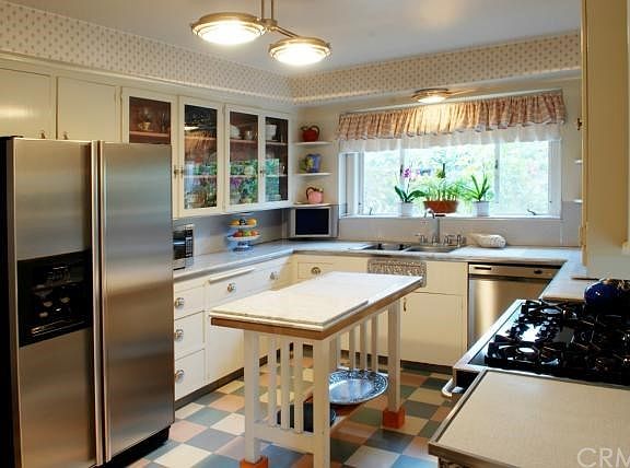 Marble Counters & Island; Stainless Steel Appliances; Custom Cabinets; View to Garden Side Yard.
