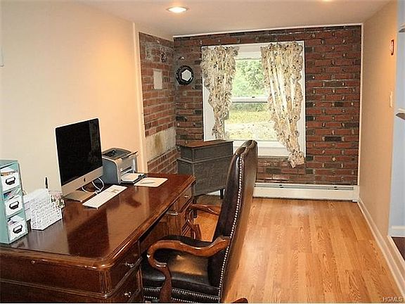 Off of the entry you will find a sitting room, what a great office or work space area.