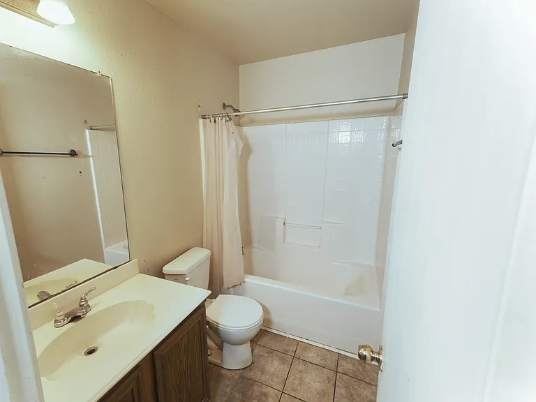 Spacious second bathroom designed for durability and ease of use, perfectly positioned to serve the guest bedrooms